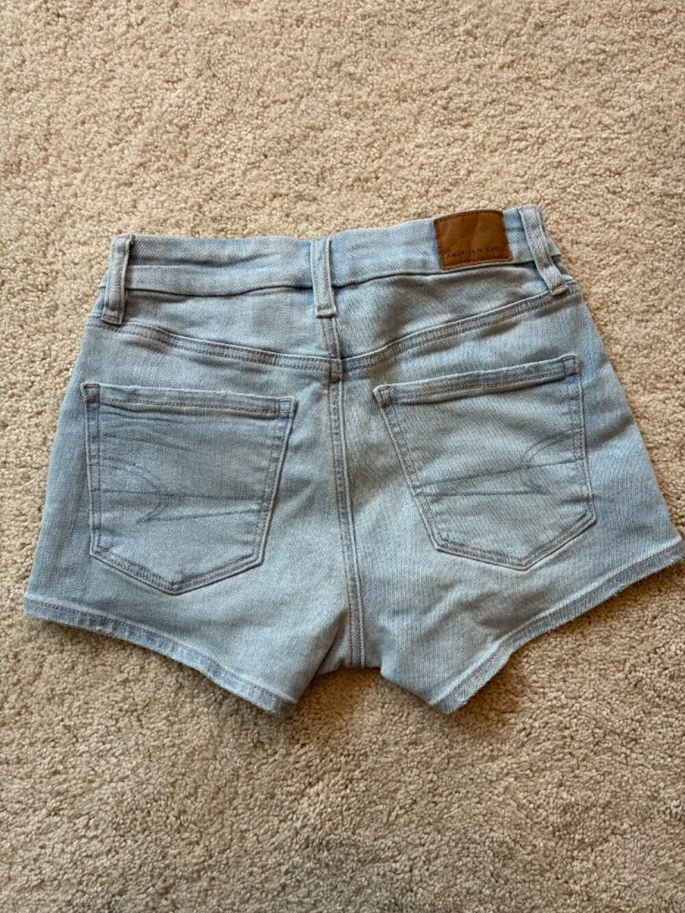 American Eagle Curvy High-Rise Shortie Stretch Jean Cross-Front Button Shorts - Picture 7 of 14